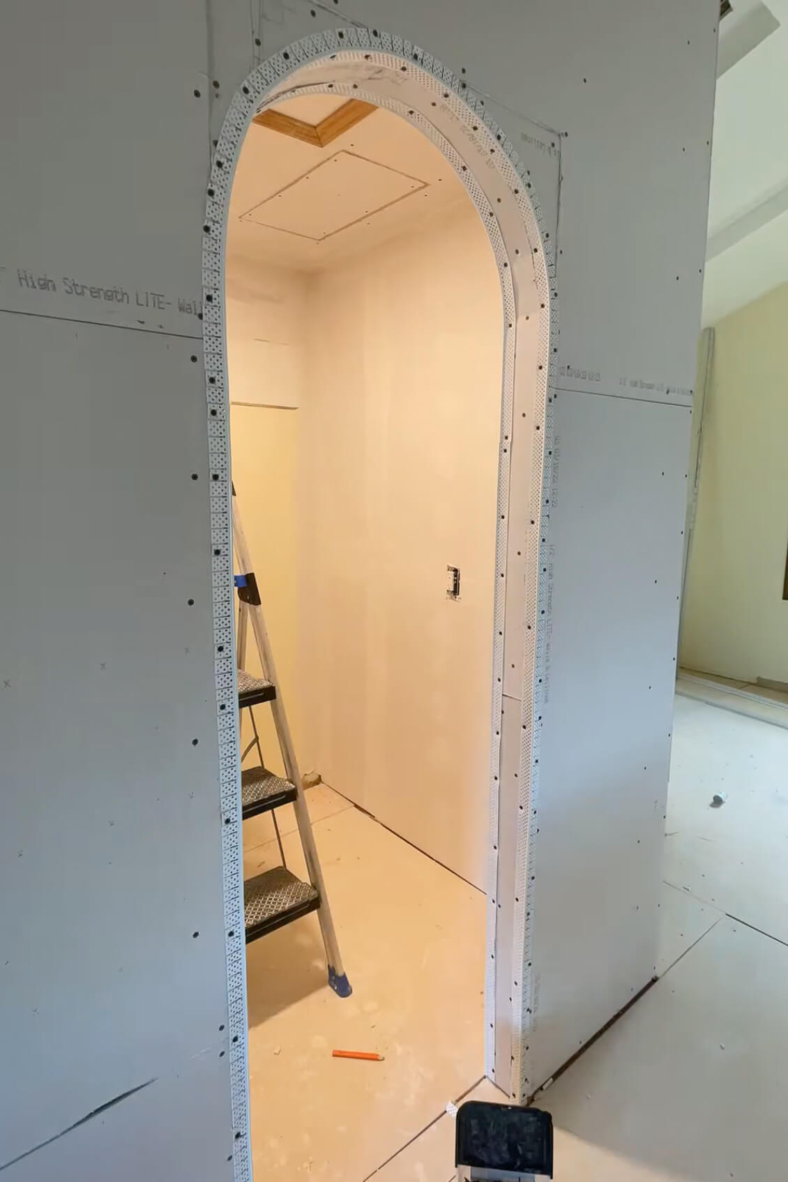Finished drywall on an arched doorway.